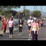 Inga high-fives a cheering fan at the 12.5 mile mark.