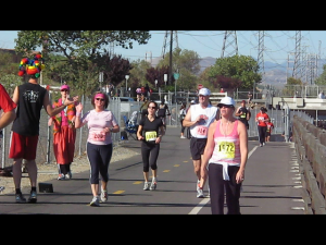 Inga high-fives a cheering fan at the 12.5 mile mark.