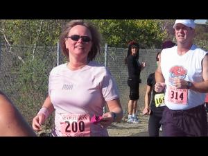 Inga hands off her head band but continues on.